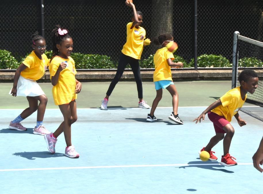 Excited Children Playing Tennis